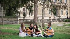 students on the lawn playing music together